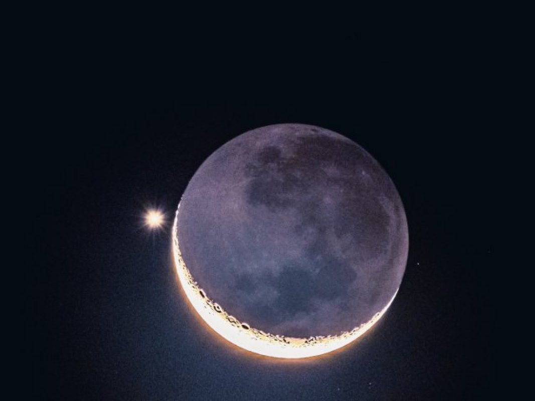 Crescent moon with earthshine and Venus close beside it