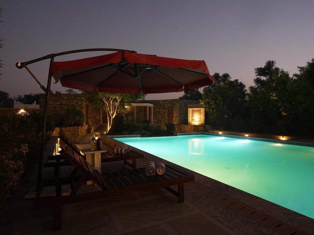Poolside loungers at dusk as the sky deepens
